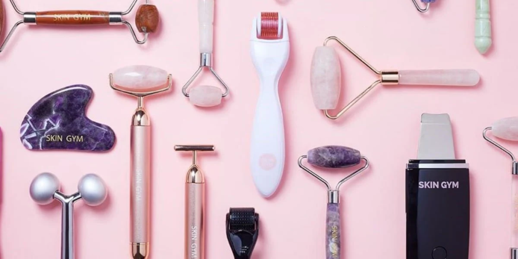 Beauty tools for skincare, haircare, and makeup, including facial rollers, makeup brushes, sponges, hair dryers, and styling tools.